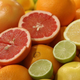 Pile of sliced citrus fruits including grapefruits and oranges